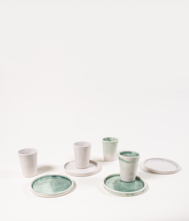 White ceramic shot glasses and matching plates